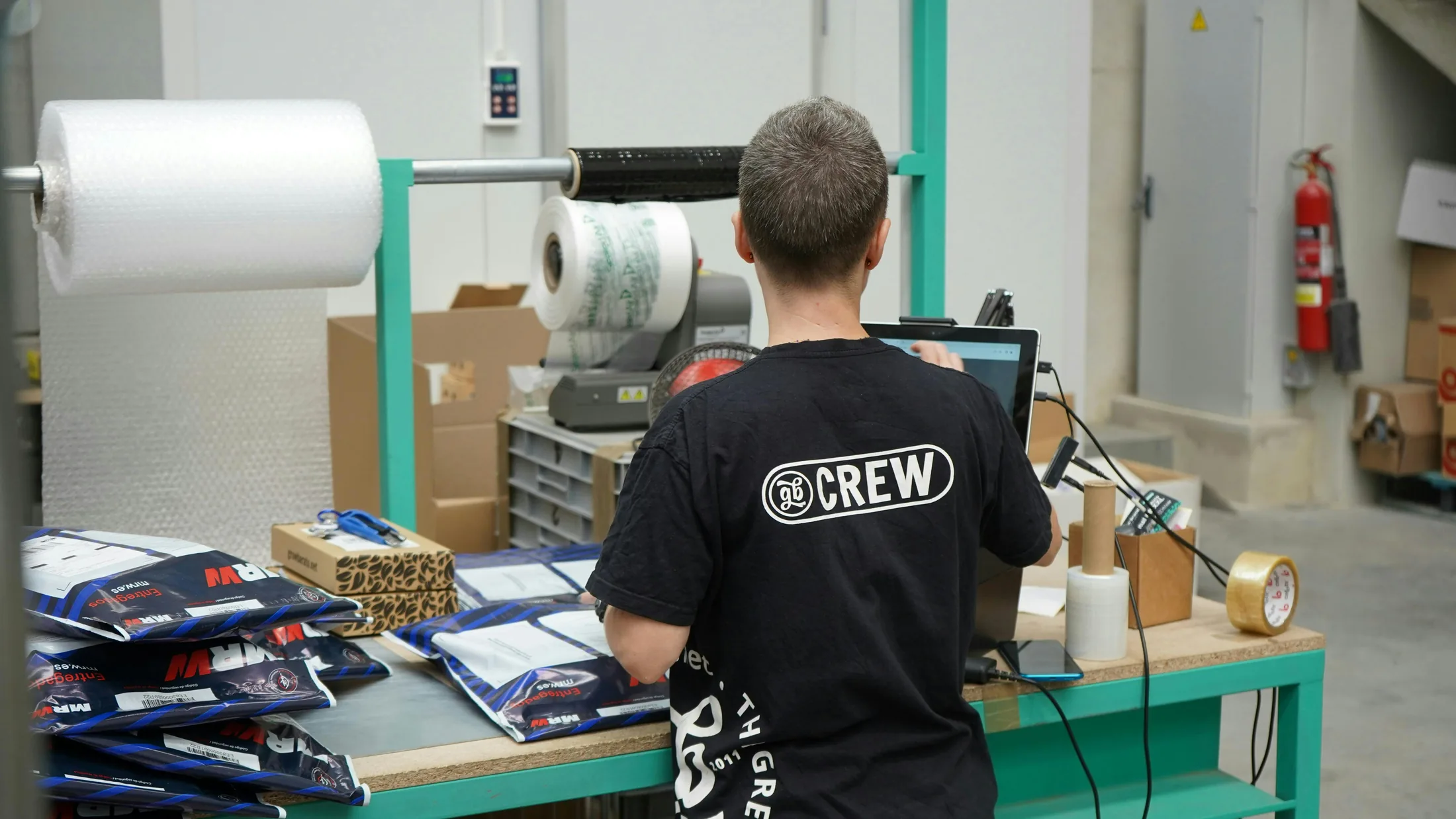 An operator preparing customer packages at a packing station