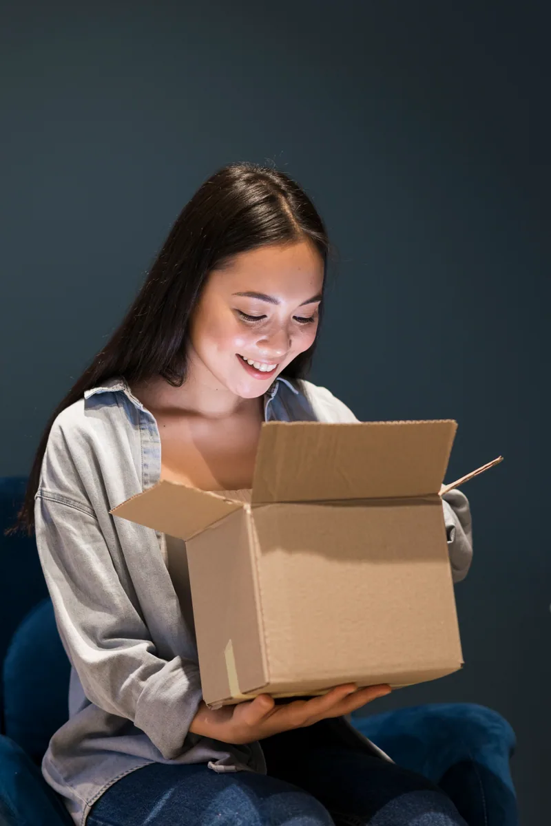 A customer opening a delivered parcel at home