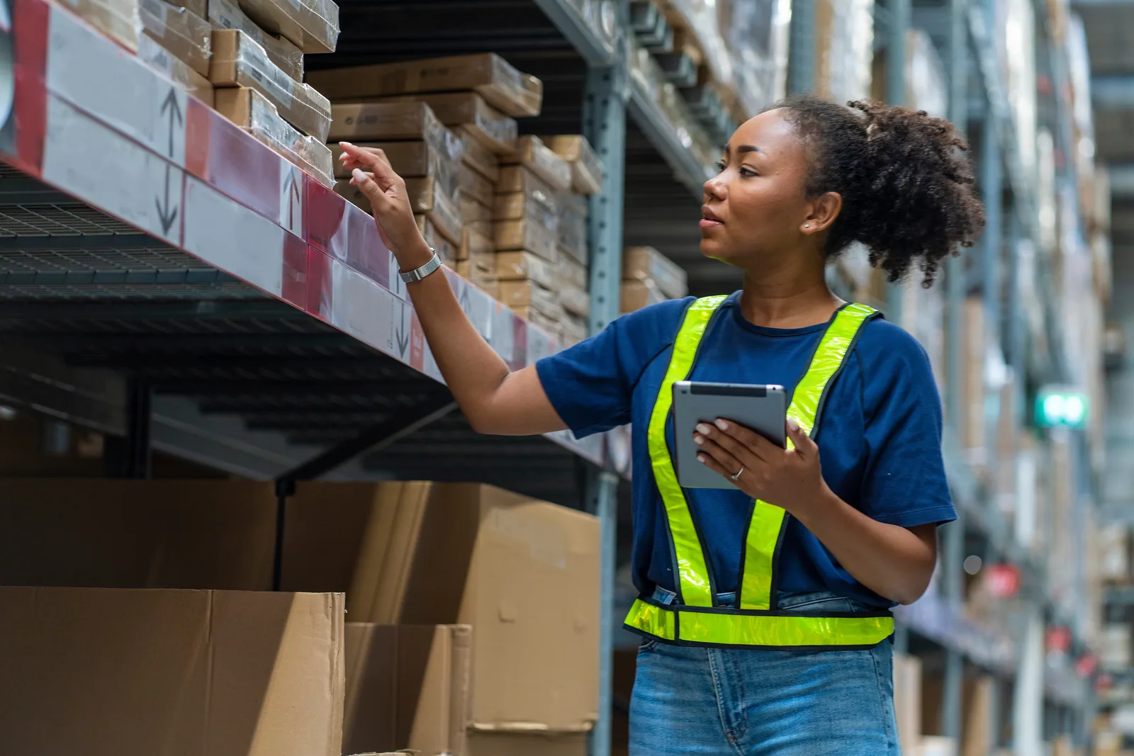 A warehouse operator working beside stored inventory