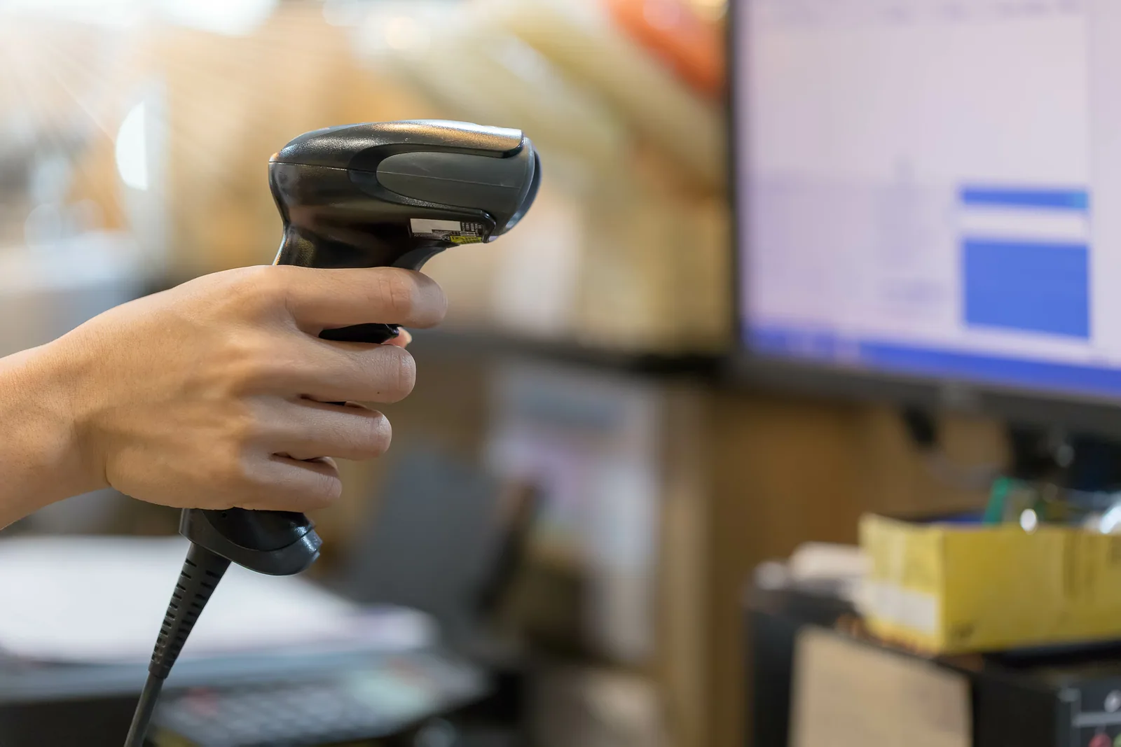 A warehouse operator scanning inventory at a workstation