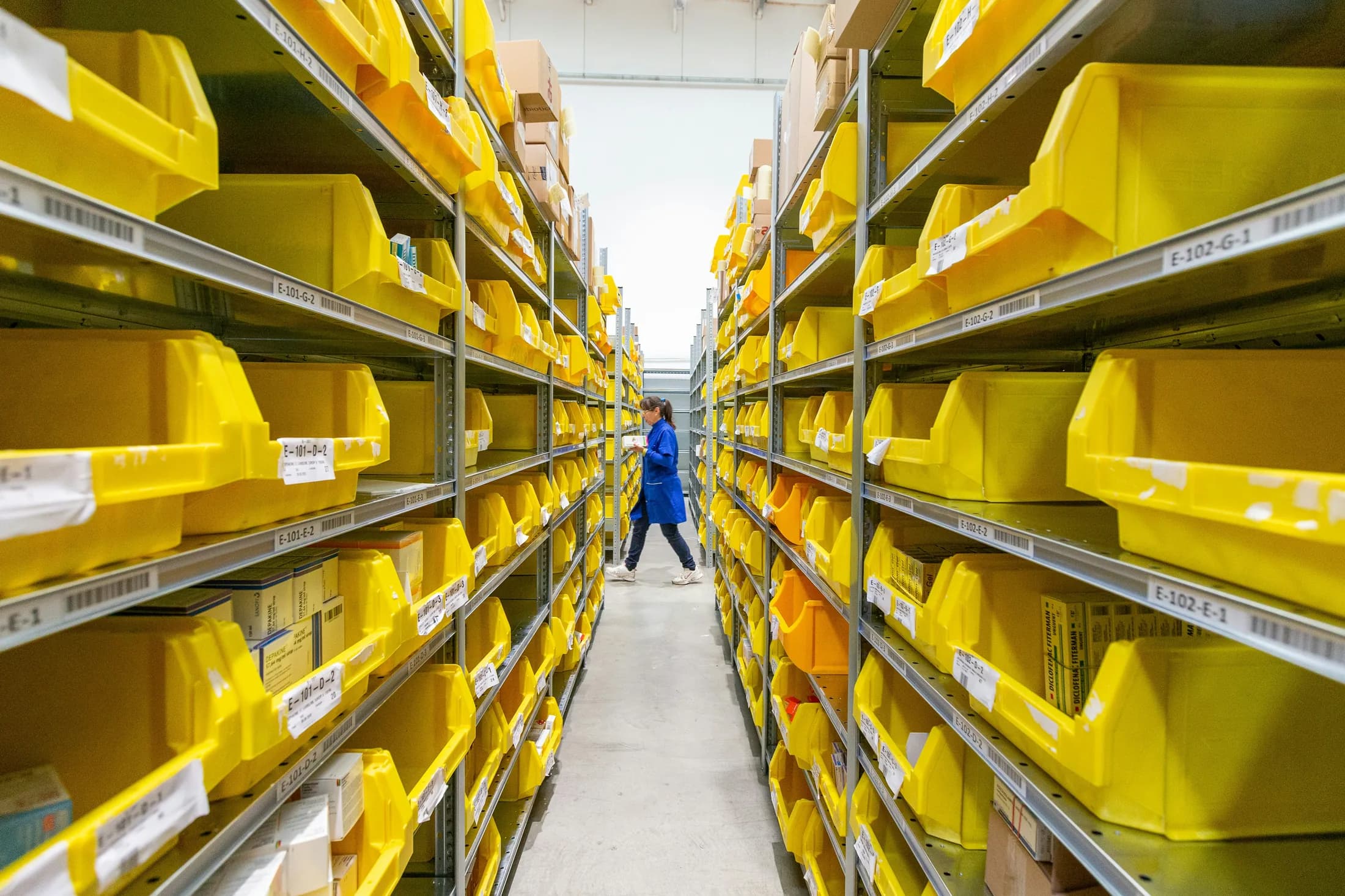 A warehouse aisle lined with organized inventory shelving